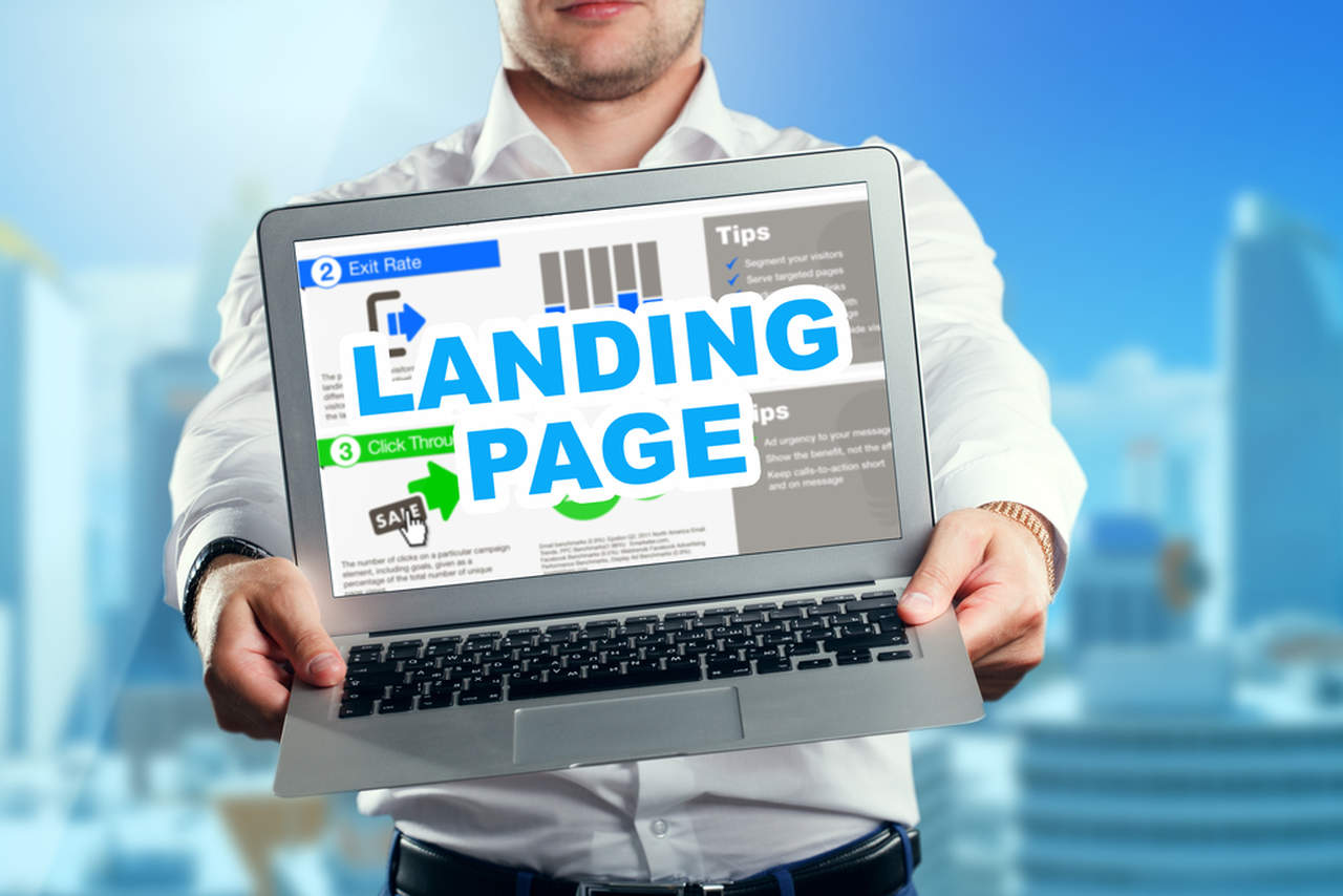 man holding landing page design on laptop